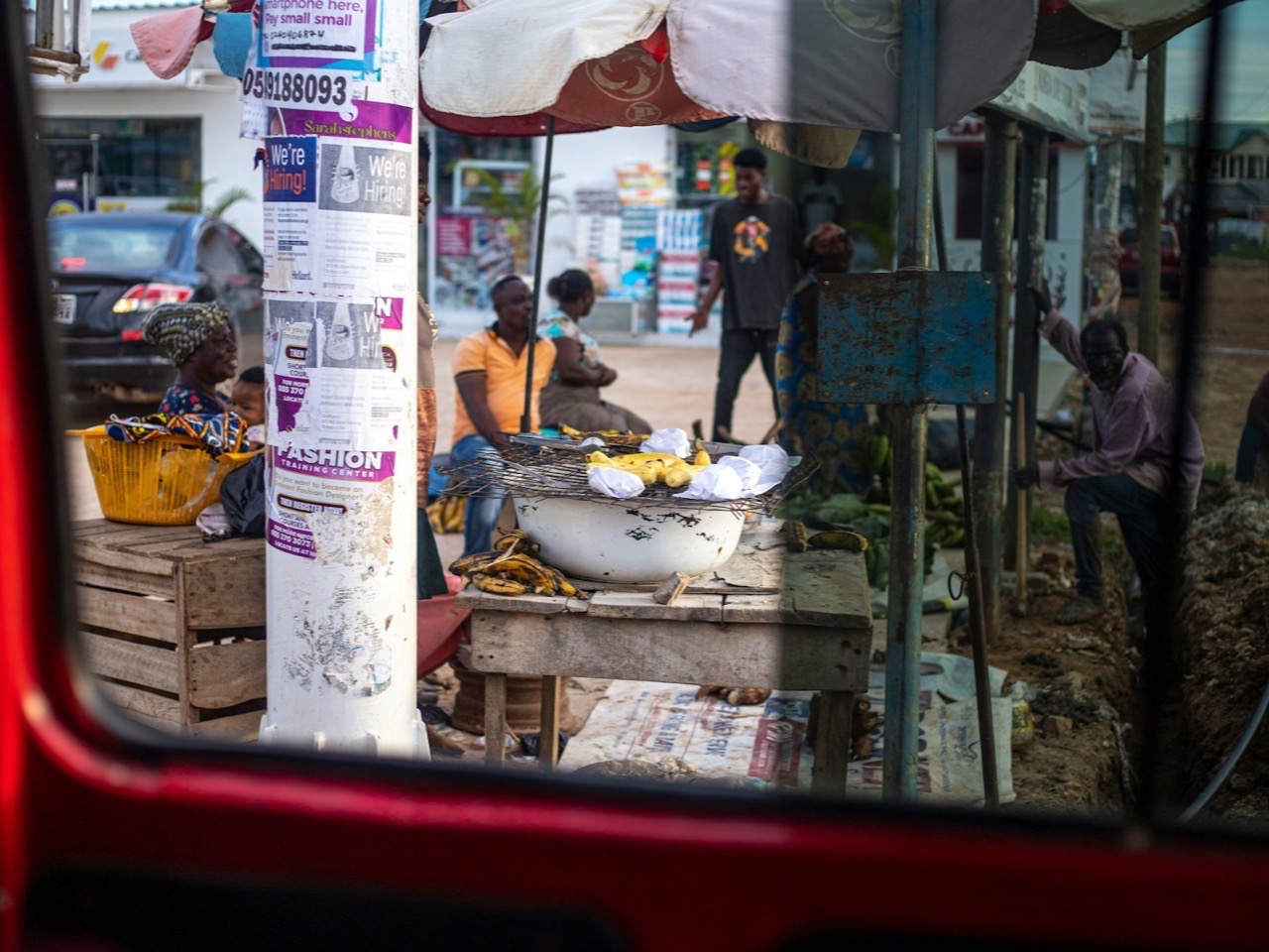 A busy Ghanaian street market with vendors, stalls and shoppers