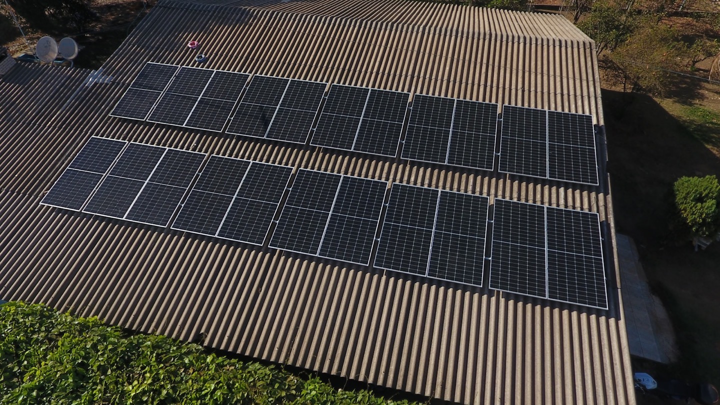 Solar panels installed across the corrugated-metal roof of a building